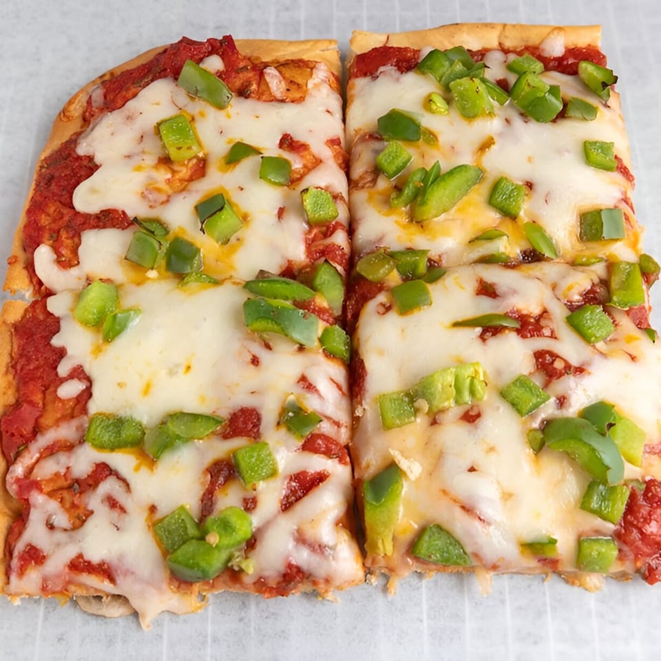 Two rectangular slices of Buzzi's Pizza with melted cheese, red sauce, and green bell peppers.